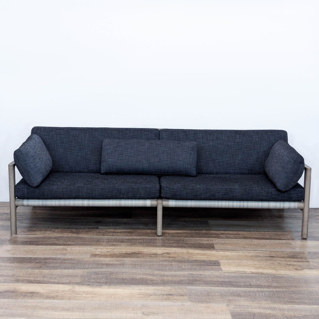 Mesa sofa by Restoration Hardware with open teak frame, handwoven wicker back, and quick-dry cushions.  