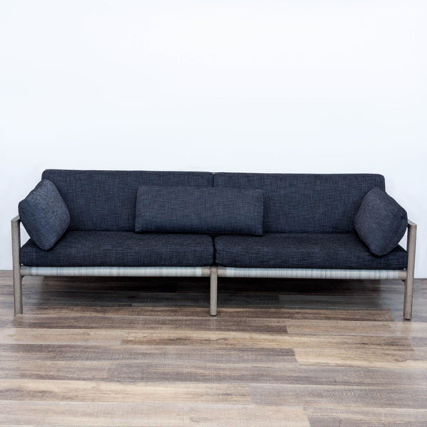 Mesa sofa by Restoration Hardware with open teak frame, handwoven wicker back, and quick-dry cushions.  