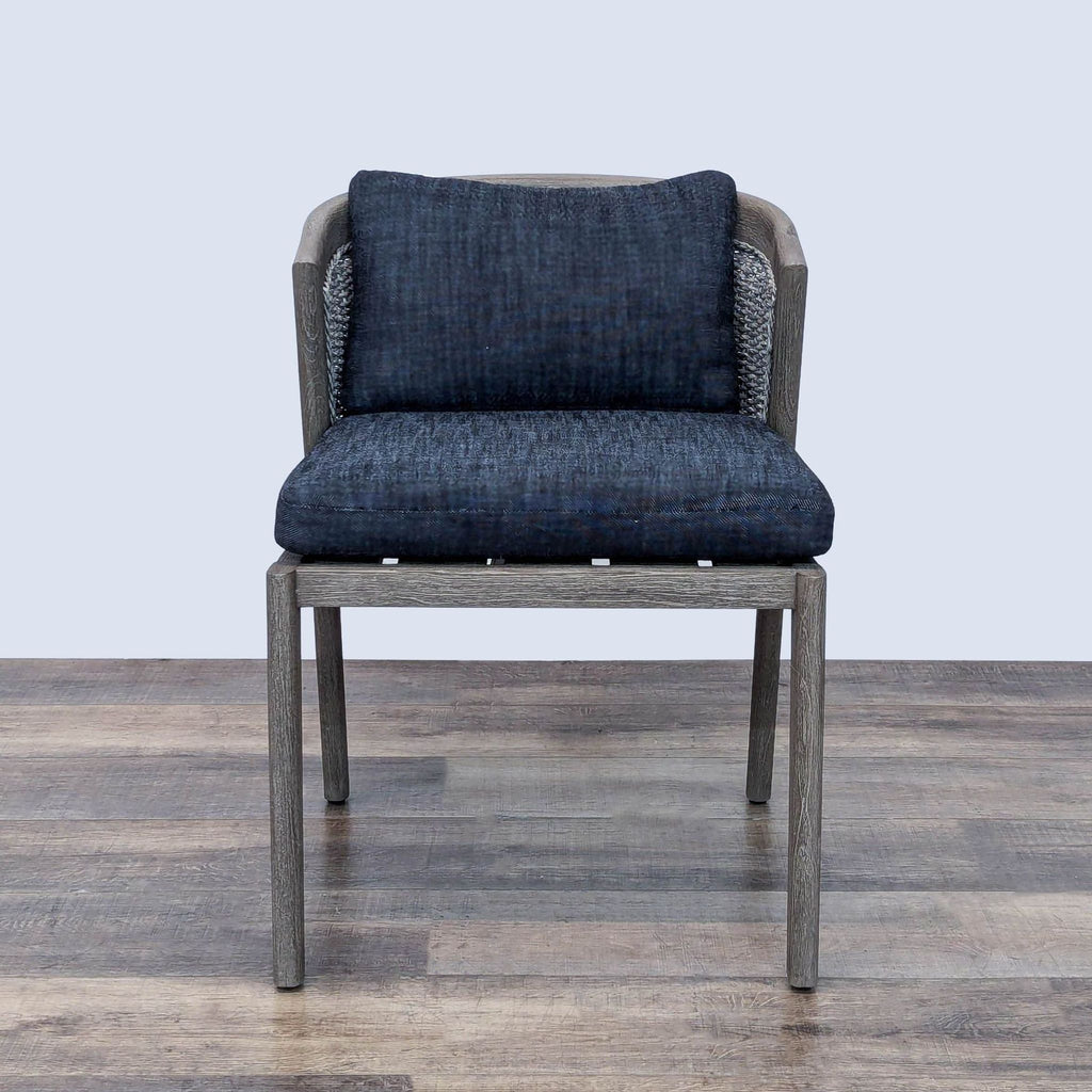 Mid-century style outdoor chair by Restoration Hardware with open teak frame and light upholstered cushions.  