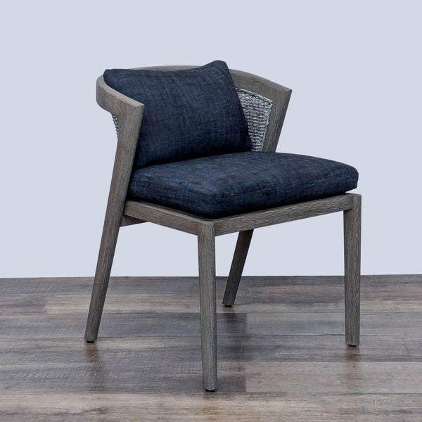 Mid-century style Malta outdoor chair with weathered teak frame, wicker back, and quick-dry cushions.