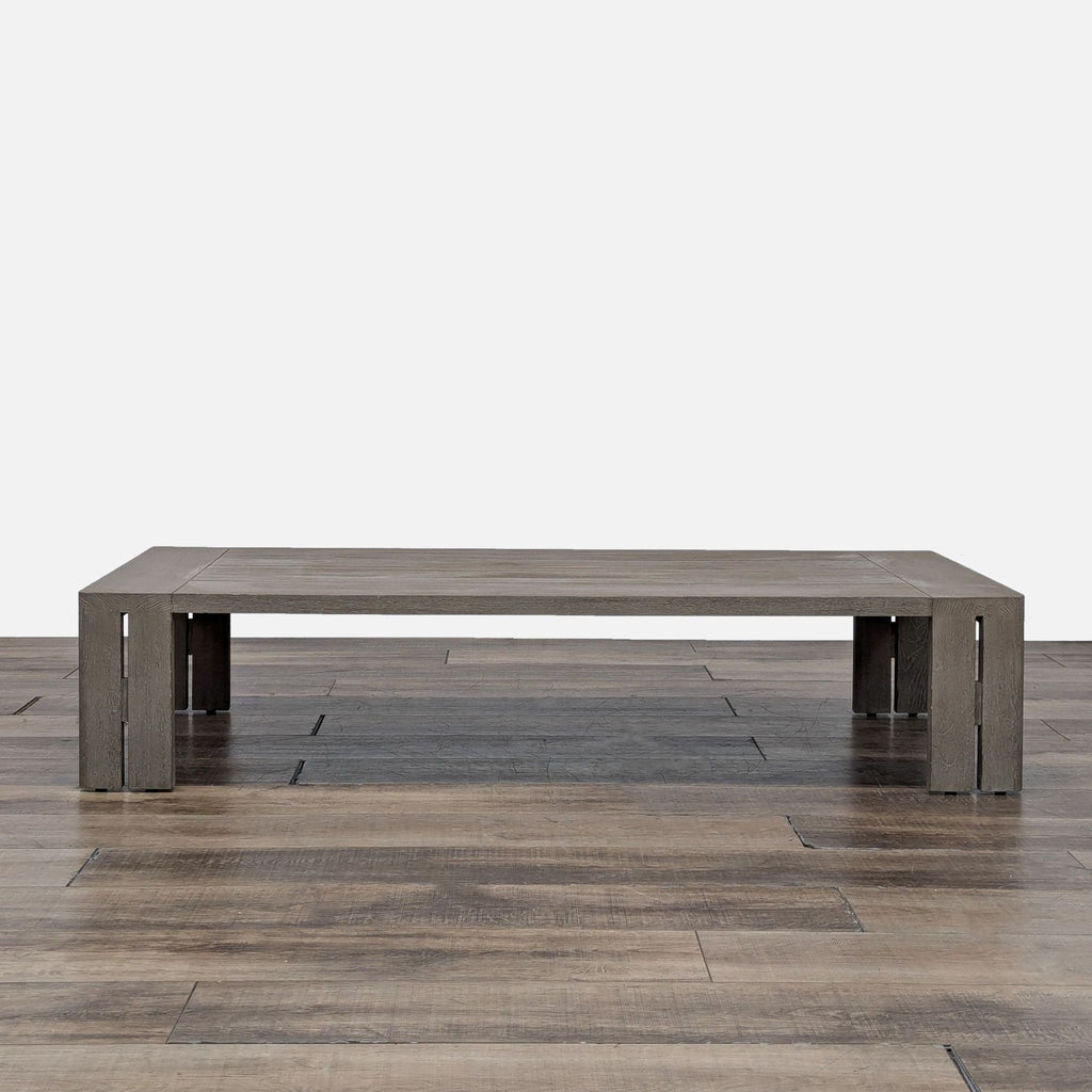 1. Reperch Matira outdoor coffee table in weathered teak with split-plane legs and a minimalist rectangular form.