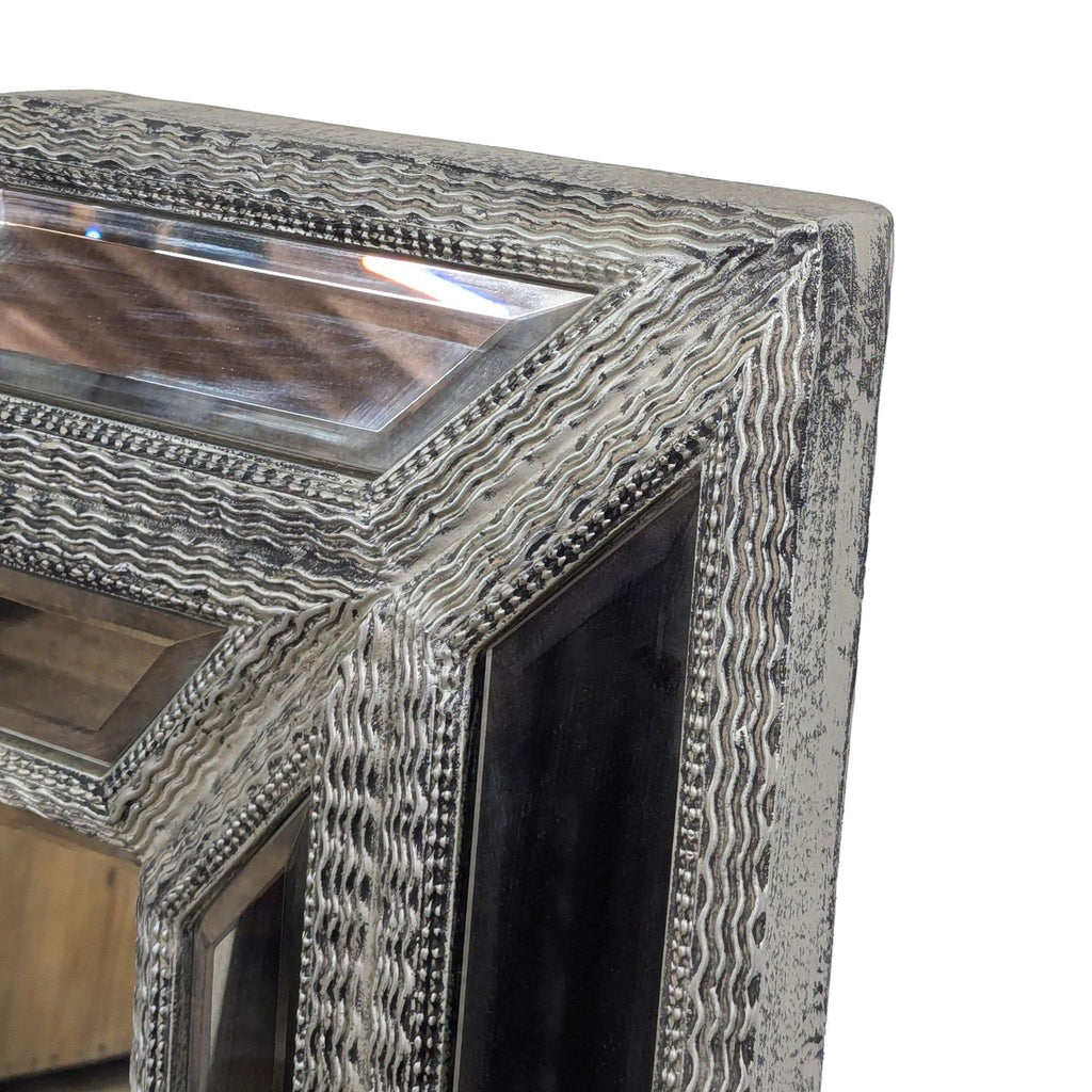 3. Close-up of the Reperch mirror reveals ornate carving and silver detailing with beveled glass inserts.