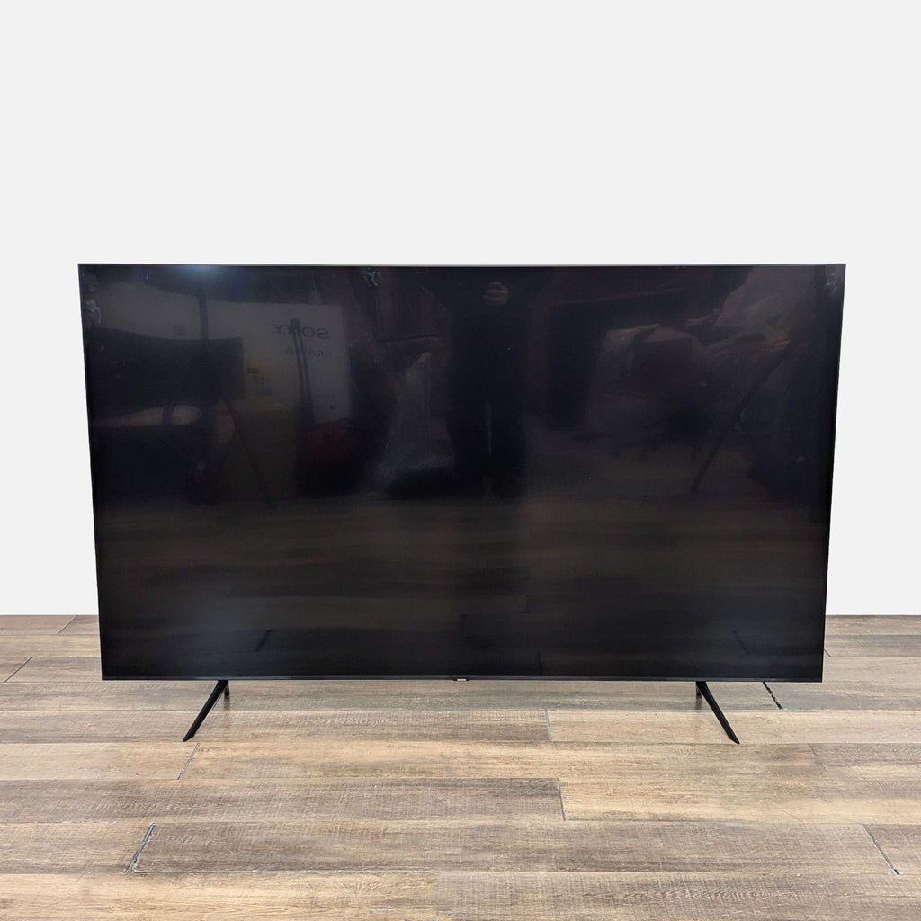 Samsung TV, 85 inches, brand new on wooden floor.