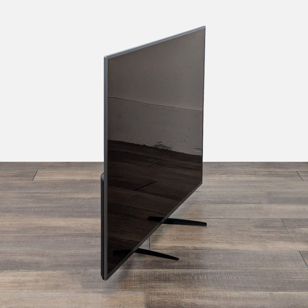 Side view of a JVC TV emphasizing its slim profile.