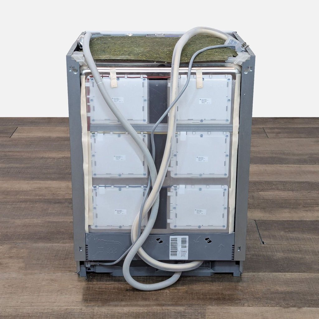 Rear view of Gaggenau dishwasher showing hoses and connections.