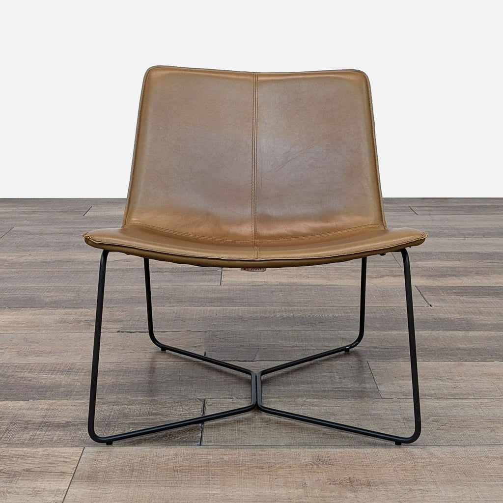 Front view of the Slope Lounge Chair with a curved leather seat and black metal frame.