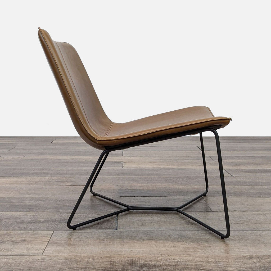 Side profile of the Slope Lounge Chair showcasing its leather upholstery and sleek black base.