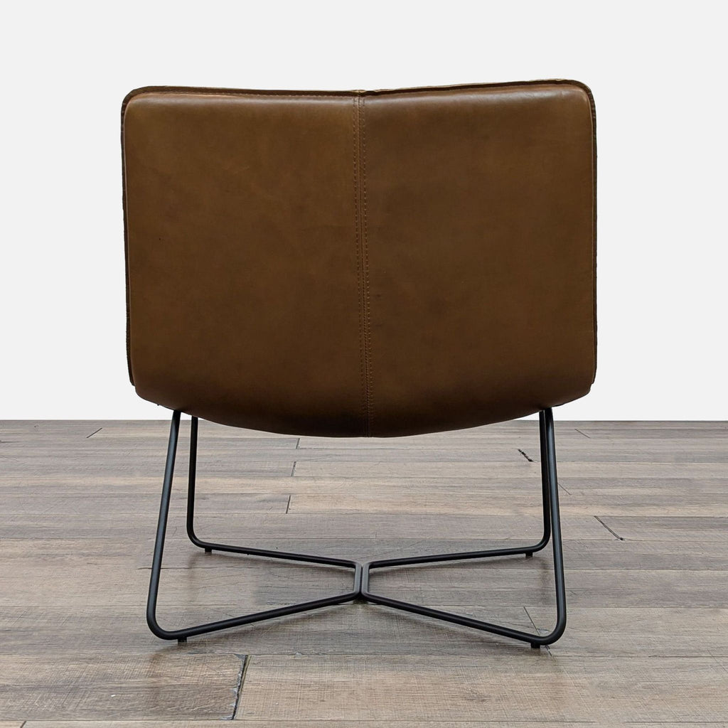 Back view of the Slope Lounge Chair highlighting leather finish and sturdy black frame.