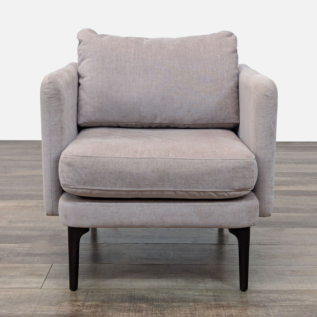 Front view of a beige twill lounge chair with wooden legs.