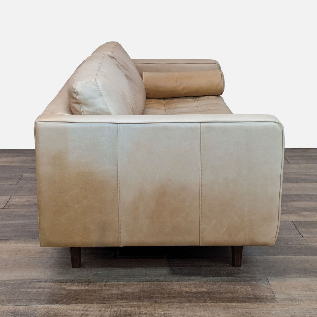 Side view showing the sleek profile of the leather upholstered 3-seat sofa.