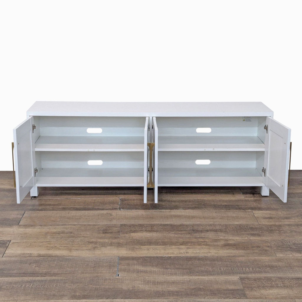 Open white cabinet with brass hardware revealing interior shelves.