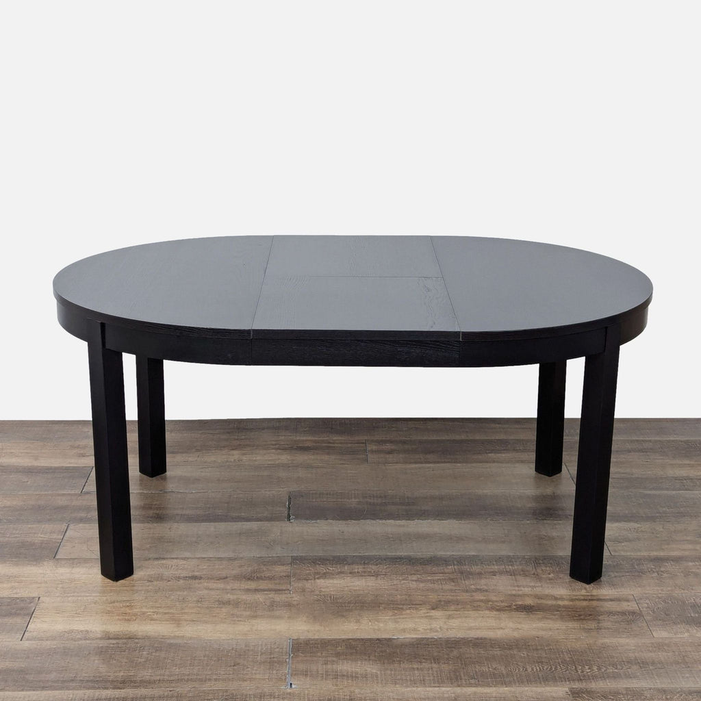 Ikea dining set featuring a black round table and four chairs.
