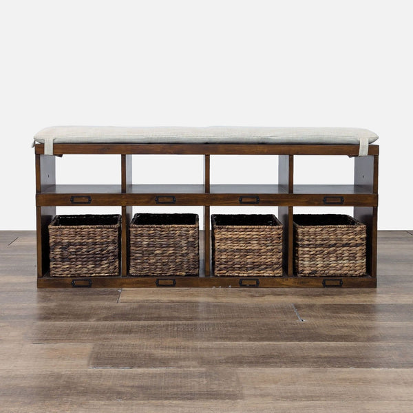 Wooden bench with four open shelves, wicker baskets, and a tufted cushion top.