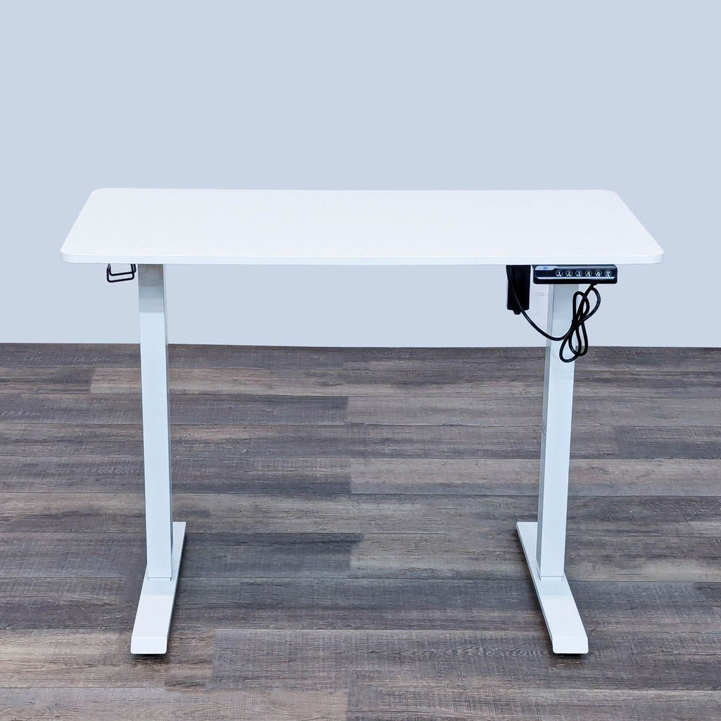 Reperch adjustable height desk with cable management.