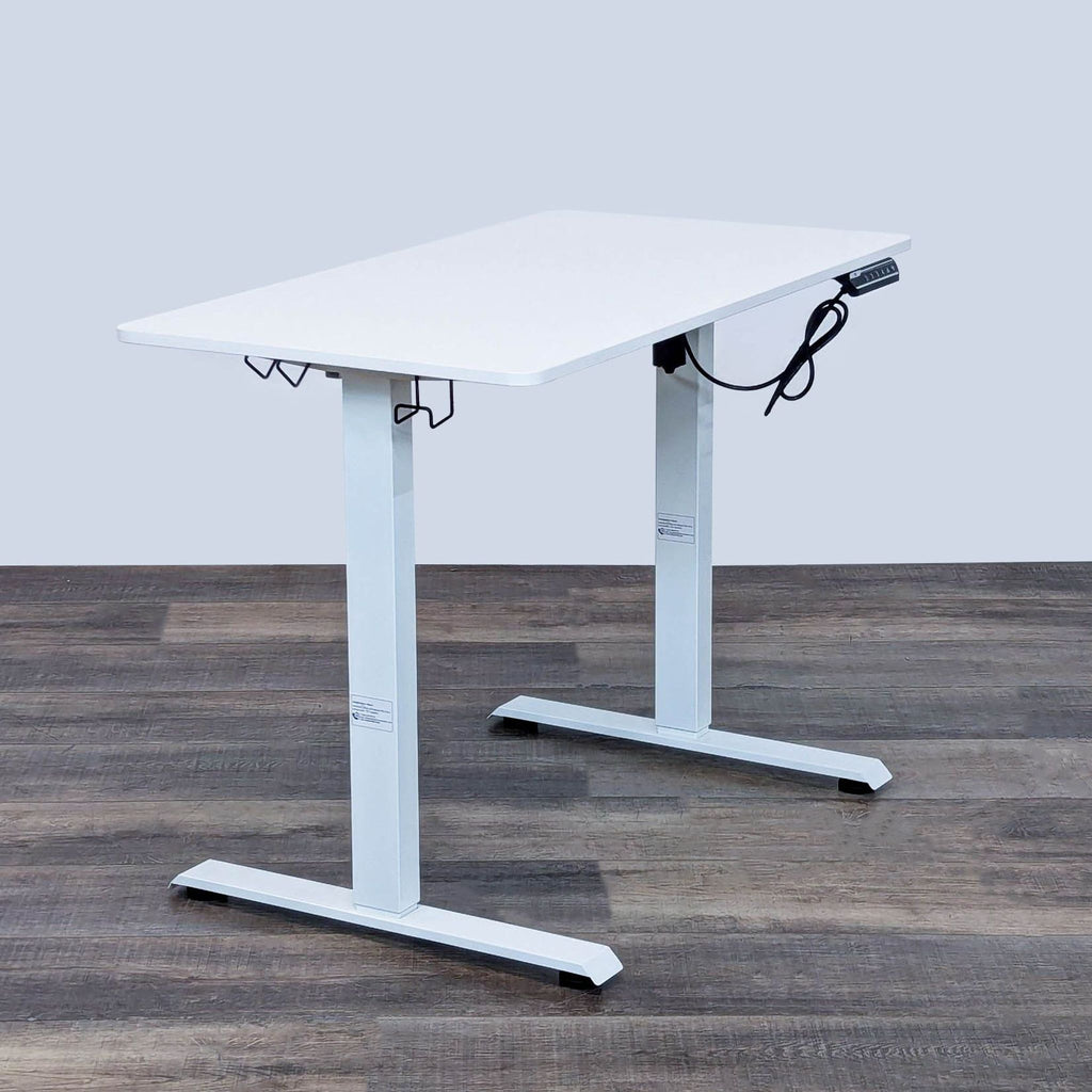 Power adjustable desk by Reperch with cable management.