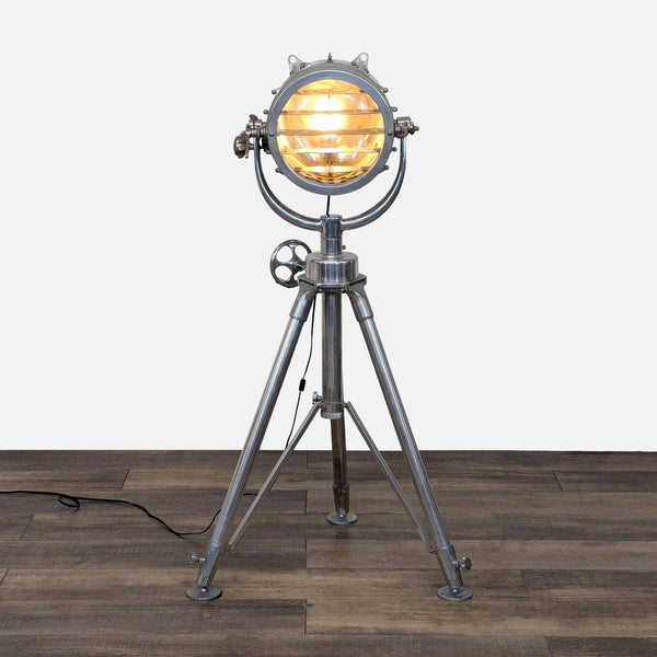 Restoration Hardware floor lamp with adjustable metal spotlight on tripod.
