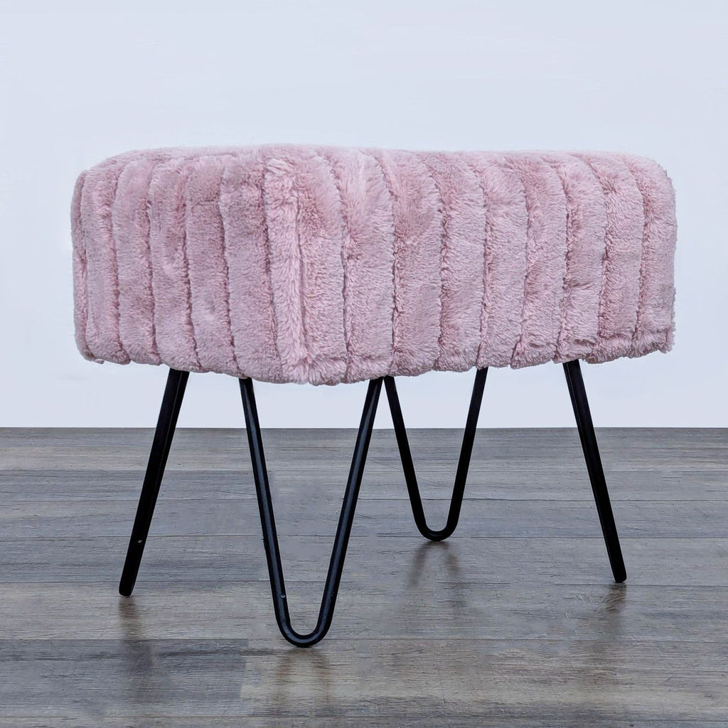 Rectangular pink stool with plush fur texture and black hairpin legs.