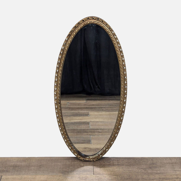 Oval wood composite mirror with decorative carvings, by Turner.