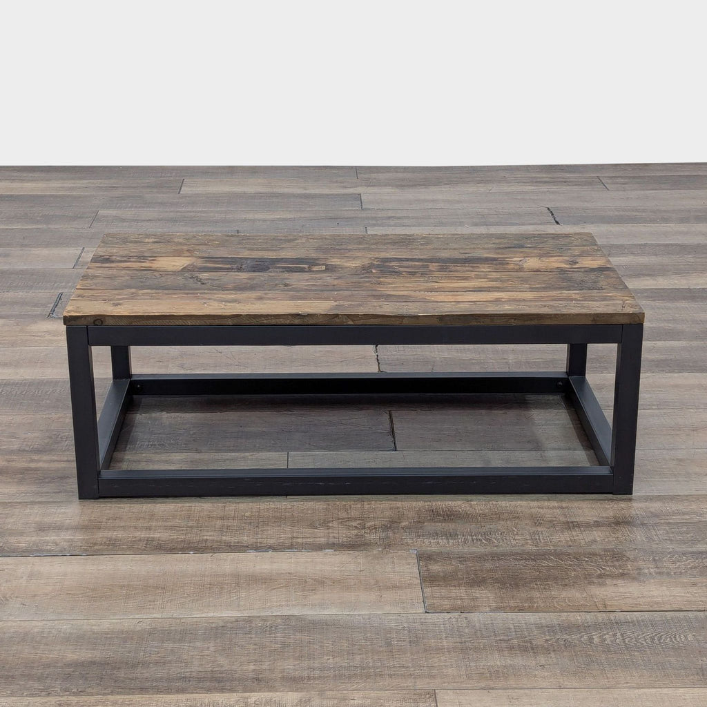 Reperch coffee table with a rustic wooden top and metal frame on wooden floor.