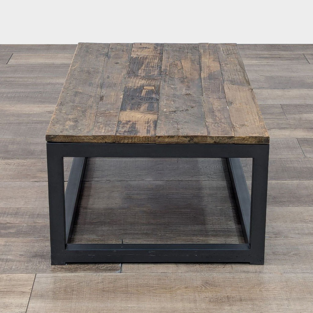 Industrial-style Reperch coffee table featuring a sturdy wooden top and sleek metal base.