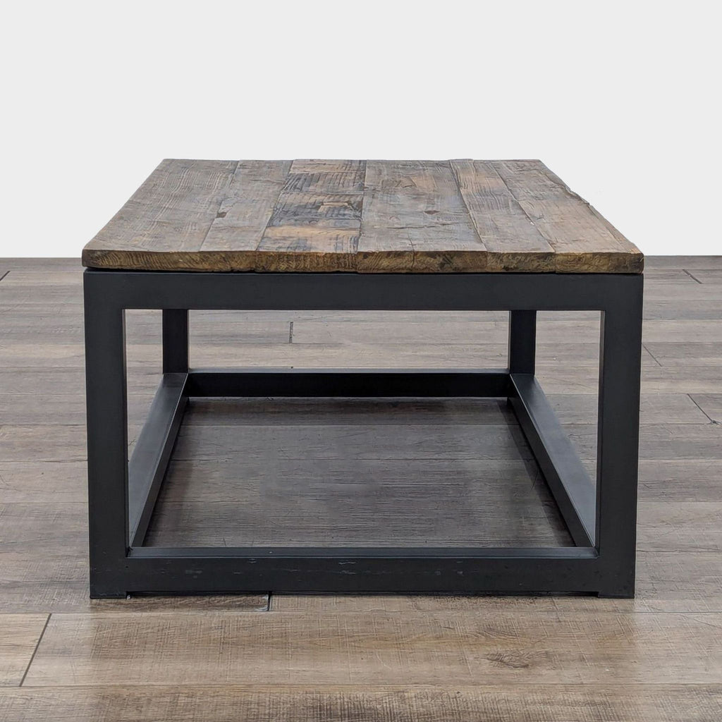 Wooden-topped coffee table by Reperch, highlighting a robust metal frame and a rustic finish.