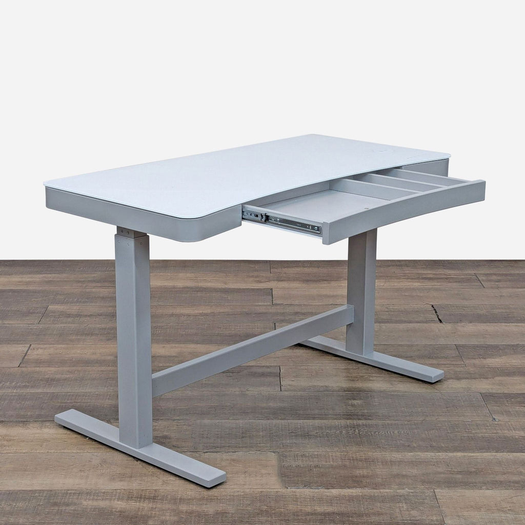 Side view of a standing desk, showcasing its USB ports and power cord integration.  