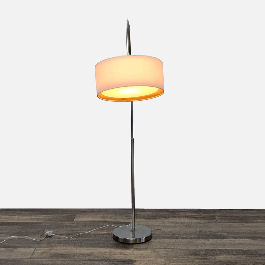 CB2 floor lamp with brushed nickel base and fabric drum shade.