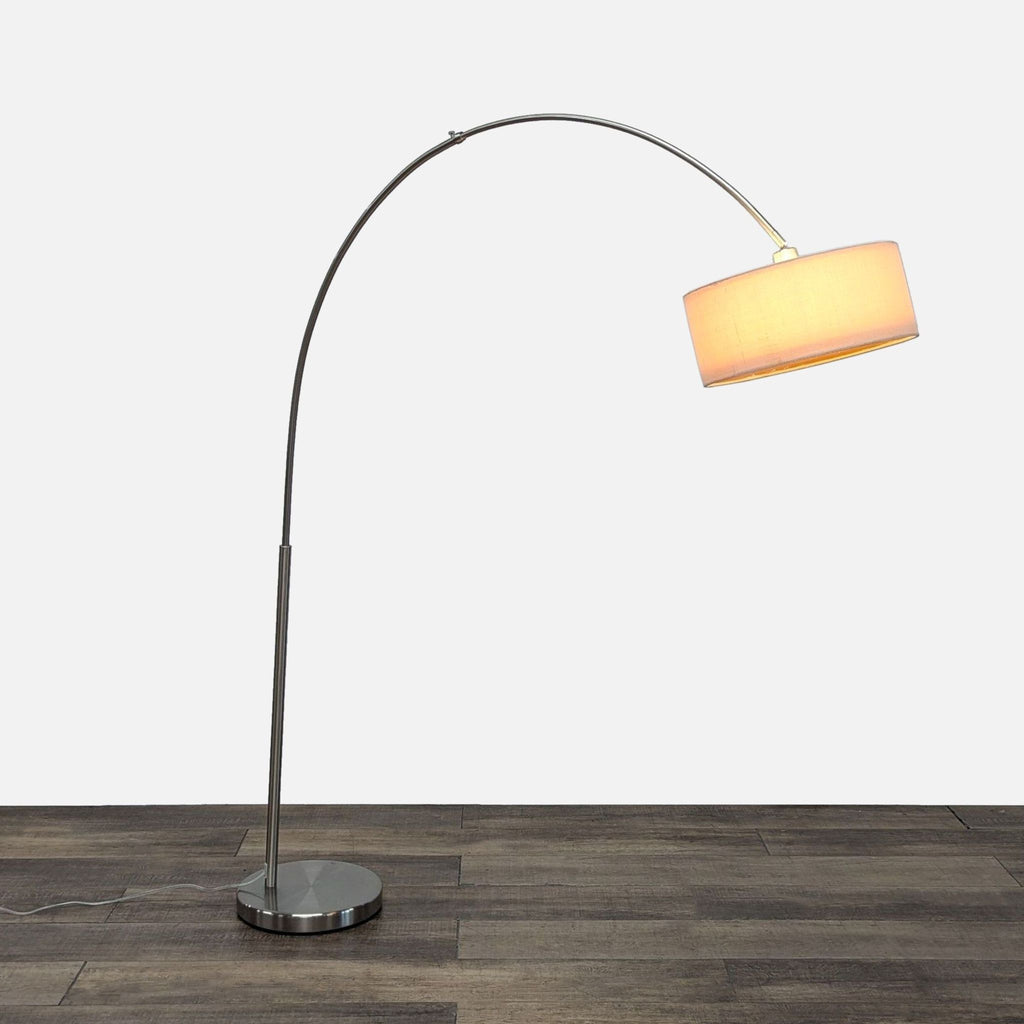 Modern floor lamp with arc design and drum shade.
