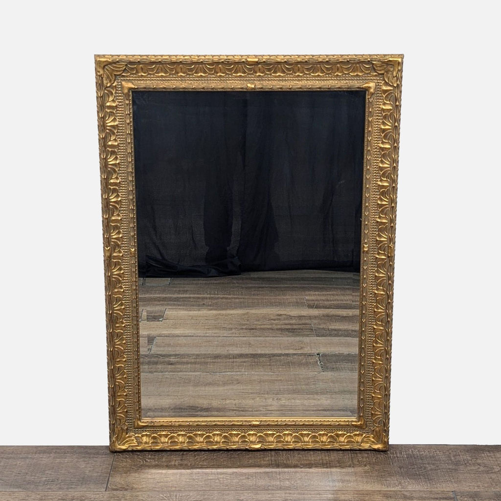 1. Ornate gold-framed mirror with intricate detailing, reflecting a wooden floor and dark backdrop.