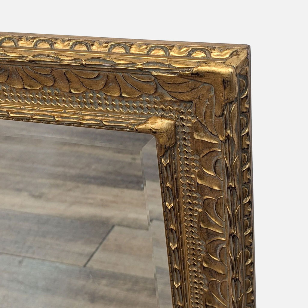 2. Close-up of the mirror's gold frame shows detailed carvings and texture against a neutral background.