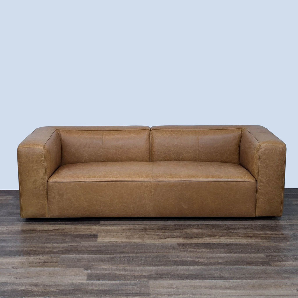 a brown leather couch with a black leather seat 