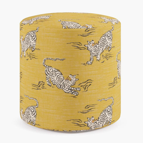 Yellow cylindrical ottoman with playful white tiger pattern on linen and cotton fabric.