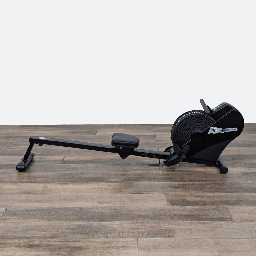 a black umbrella sitting on top of a wooden floor 