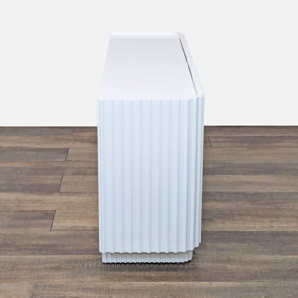 a white refrigerator sitting on top of a floor 