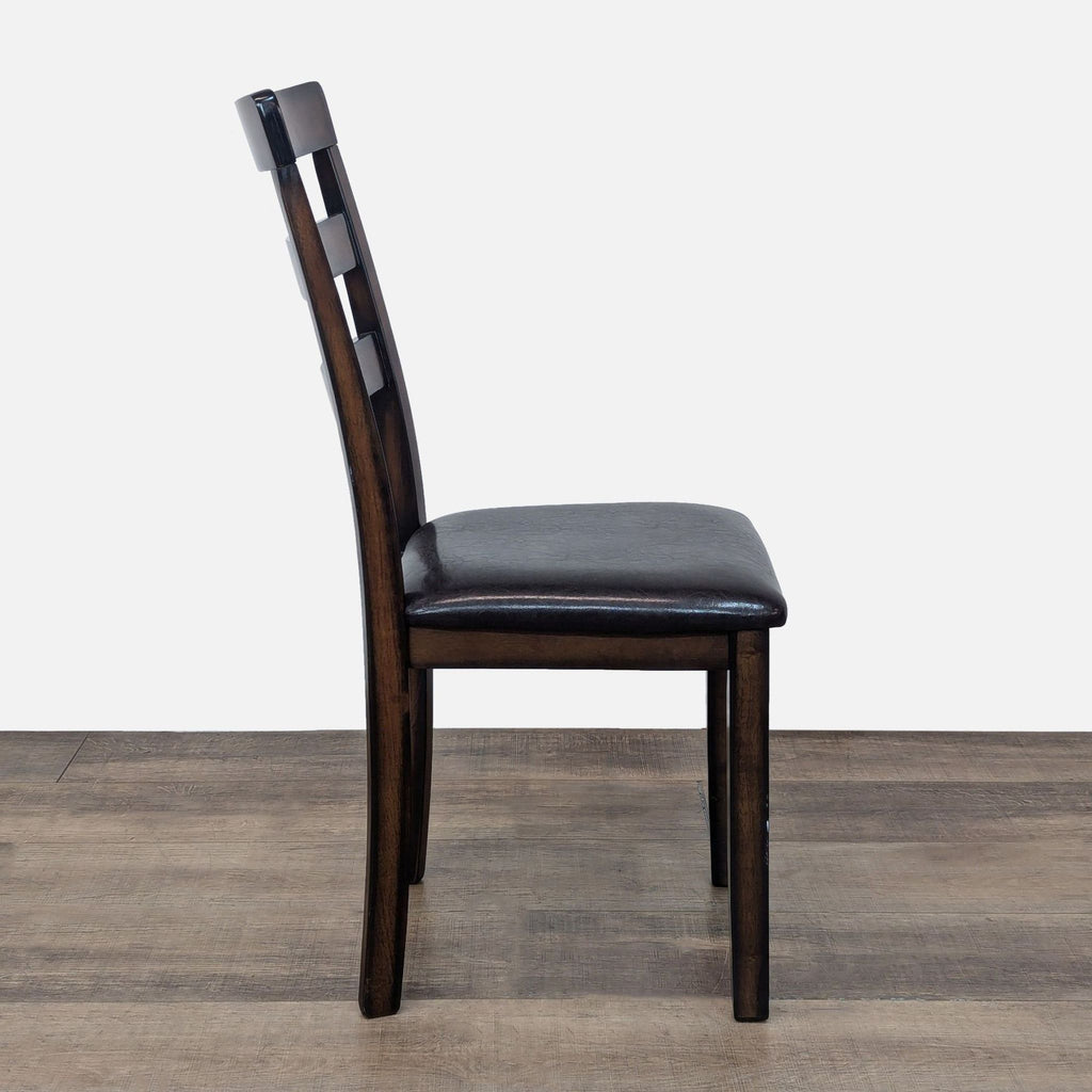 a chair with a wooden handle sitting on a floor 