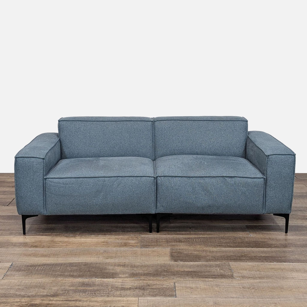 a couch with a black leather couch cushion 