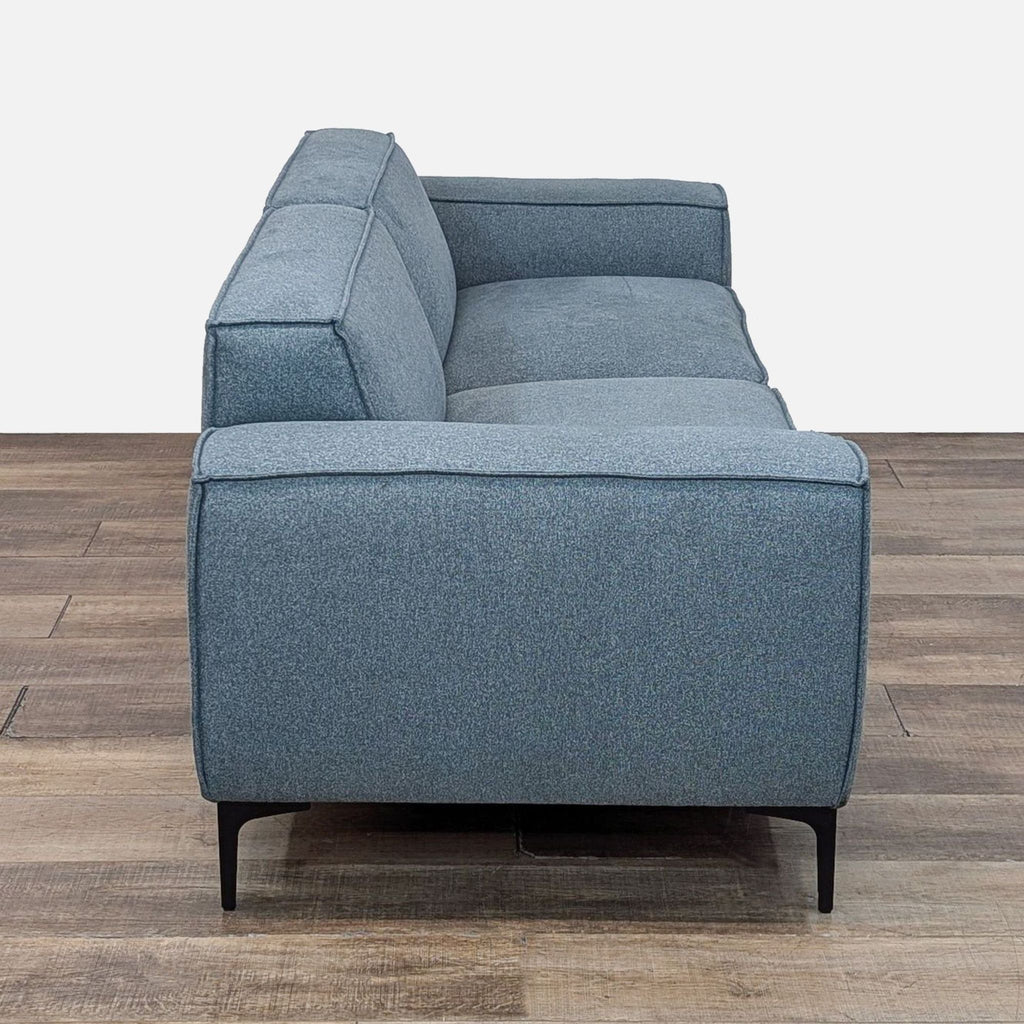 a couch with a black leather seat and a black leather chair 