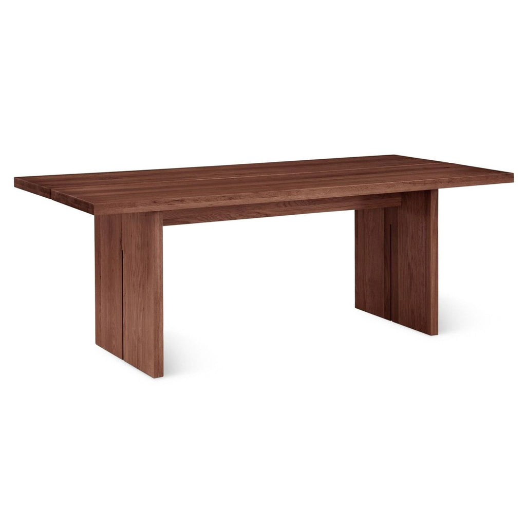 a wooden bench sitting in front of a wooden wall 