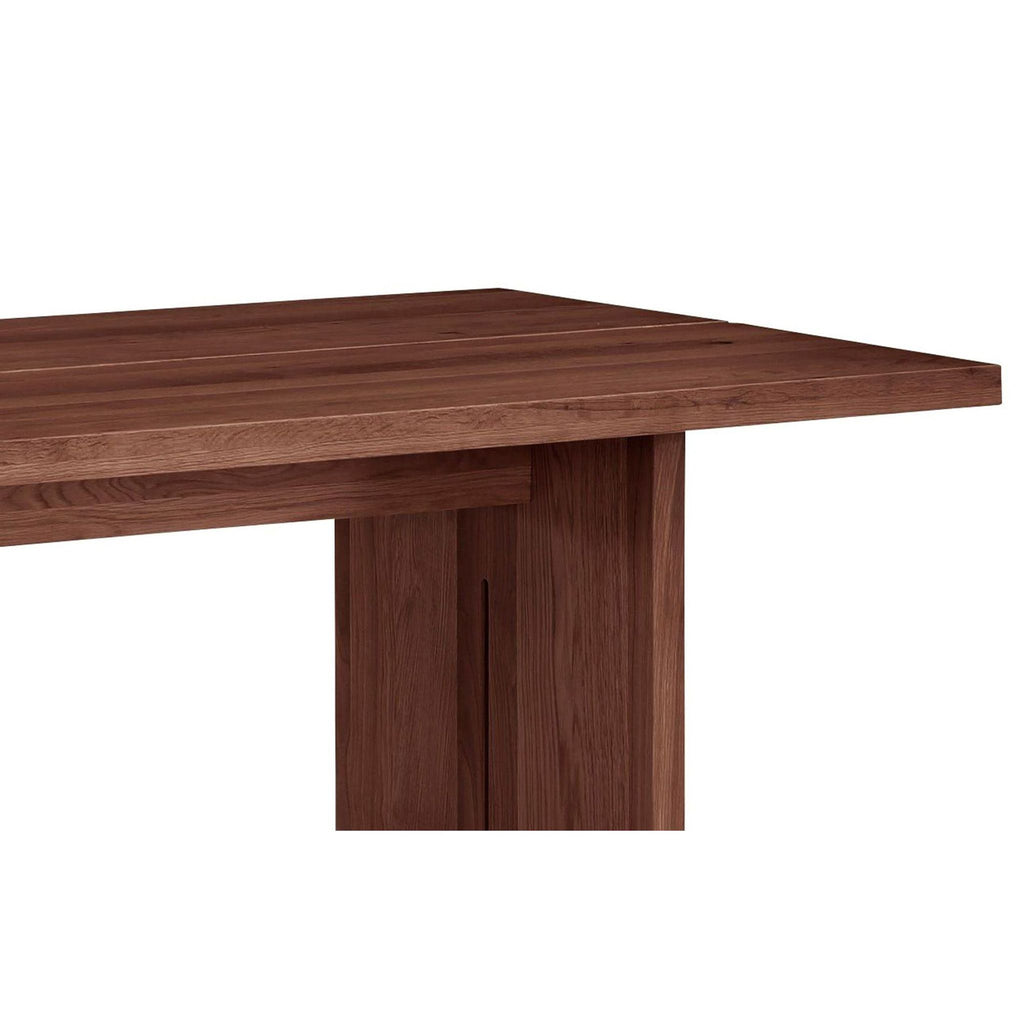 a wooden table topped with a wooden chair 