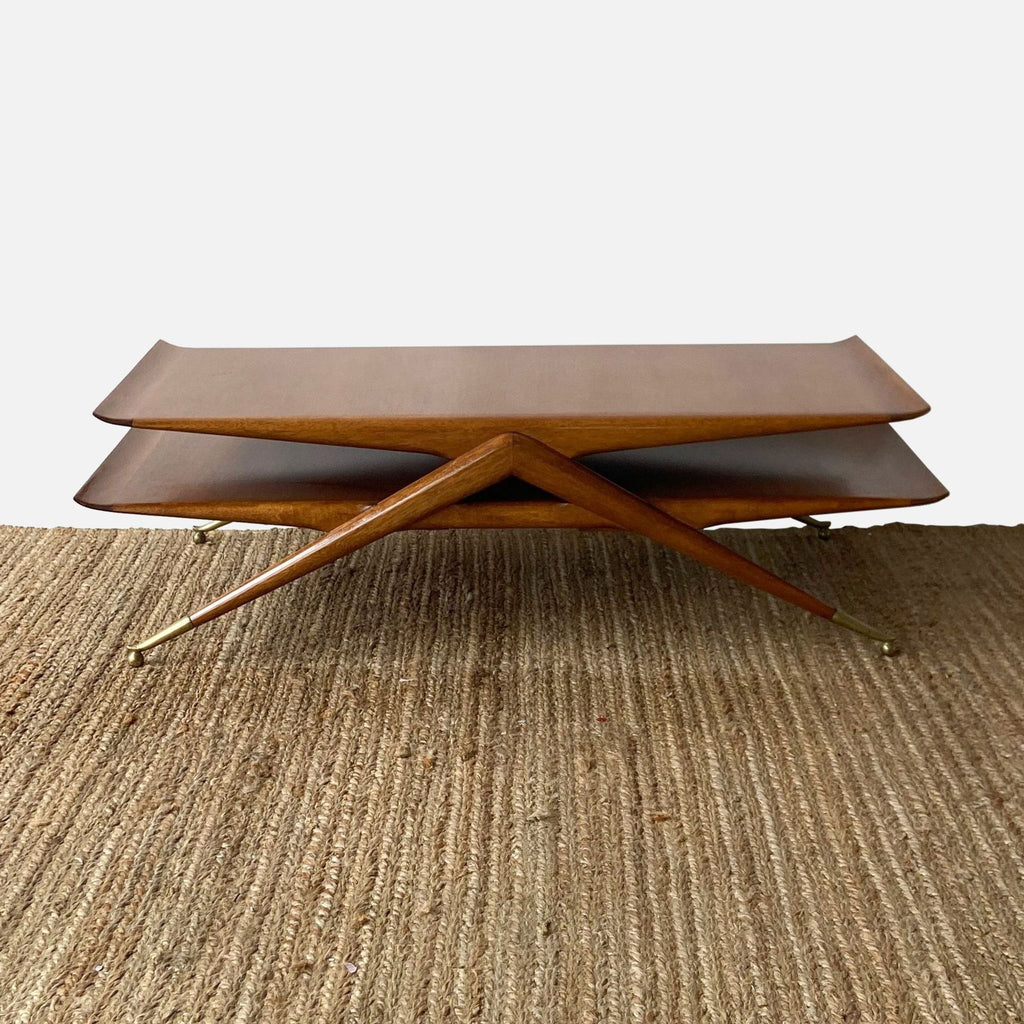 Elegant vintage coffee table featuring sharp-angled legs, brass ball feet, and stylish curled ends on both tiers.