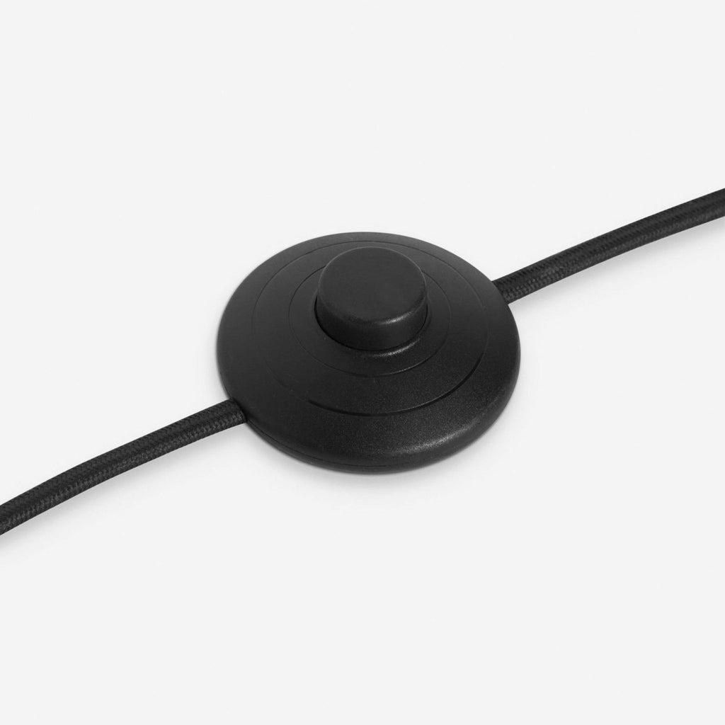 a black and white mouse on a white surface 