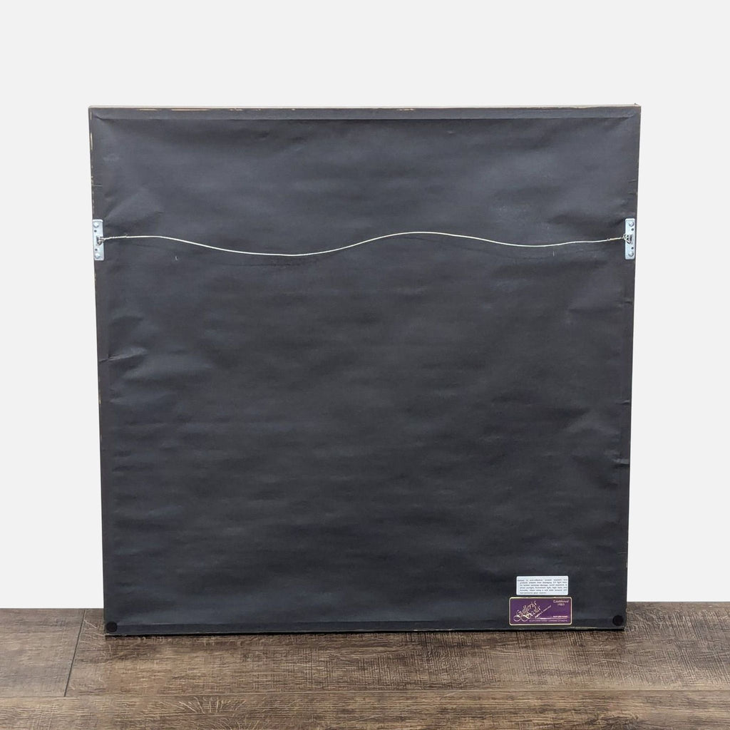 a black suitcase sitting on a wooden floor 