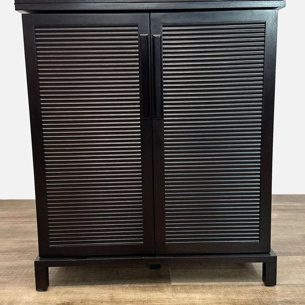 Espresso-finished mahogany bar cabinet with sliding top, wine bottle shelves, and stemware racks from Crate & Barrel.  