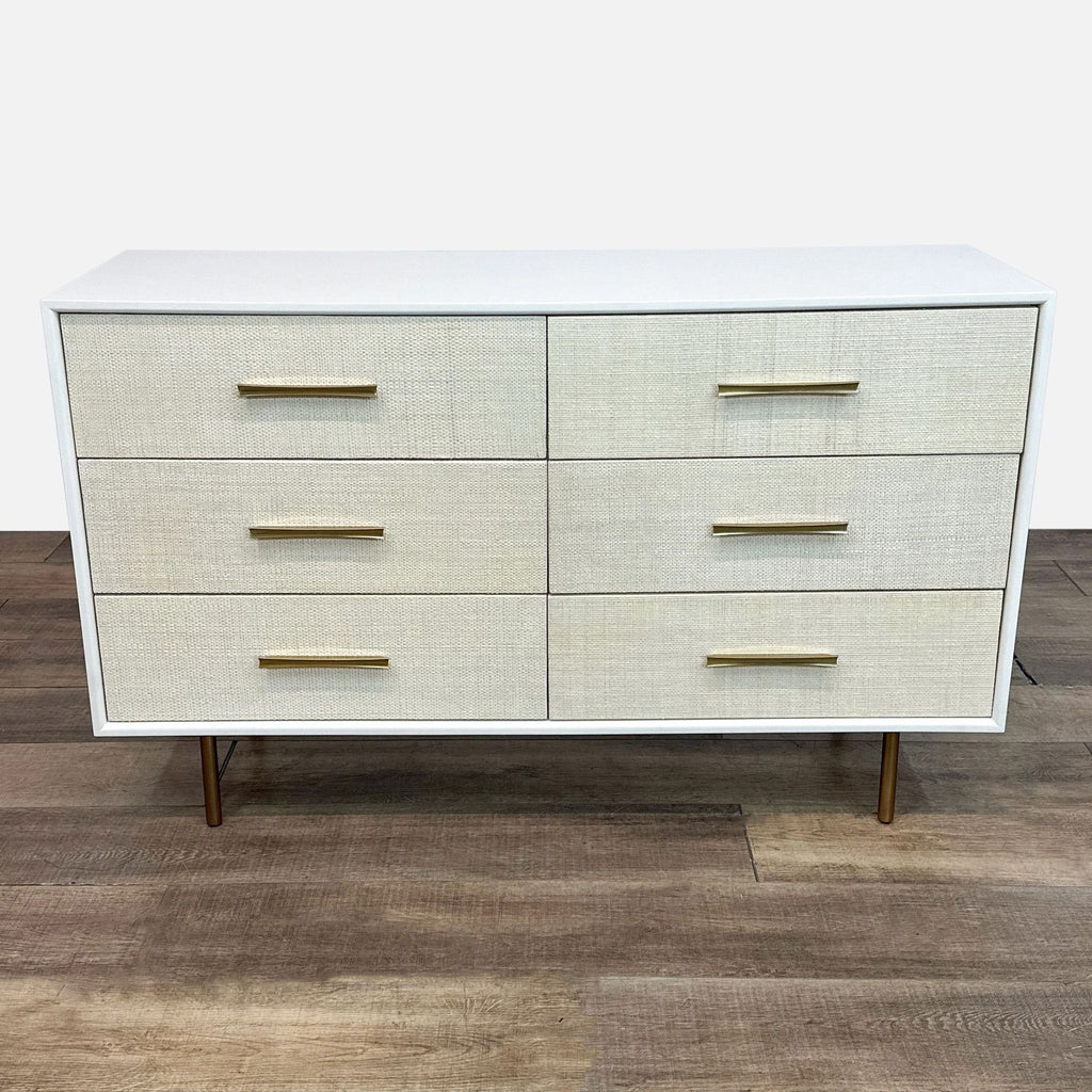 a white cabinet with a black and white striped wall 
