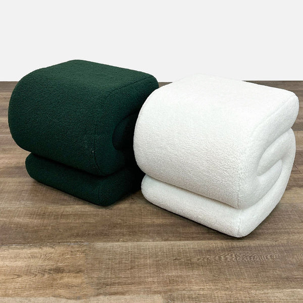 a white bed with two pillows and a white blanket 