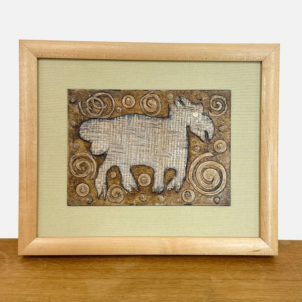 1. Framed mixed media artwork by Yvonne Browne, featuring a textured animal silhouette and earthy swirl patterns.