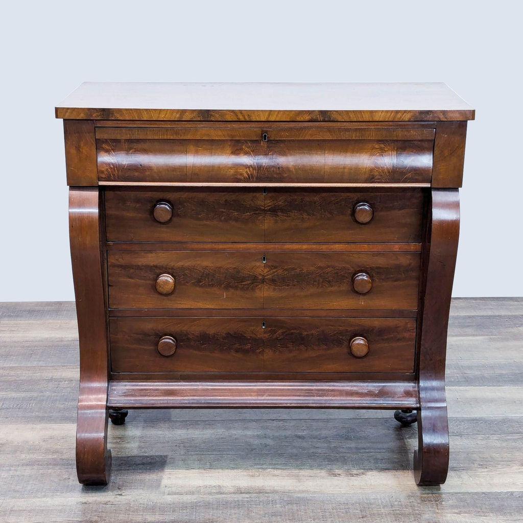 Empire style mahogany dresser with curved front and four drawers by Reperch.