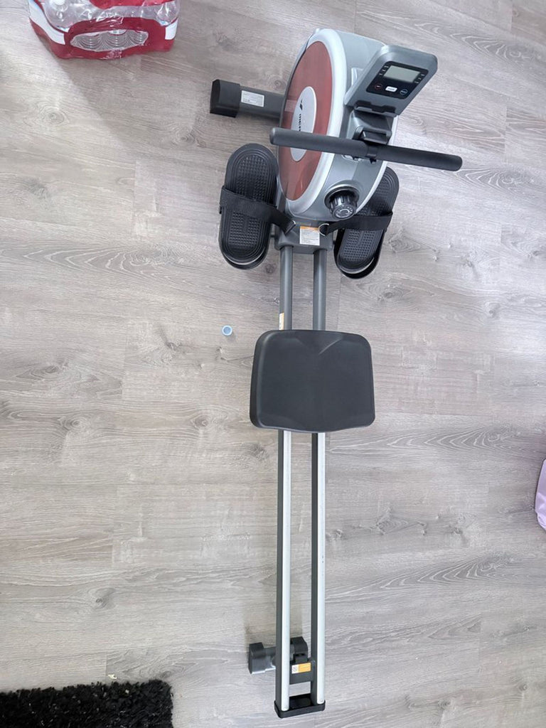 1. Rowing machine gym equipment on display, with sturdy frame and digital console.  