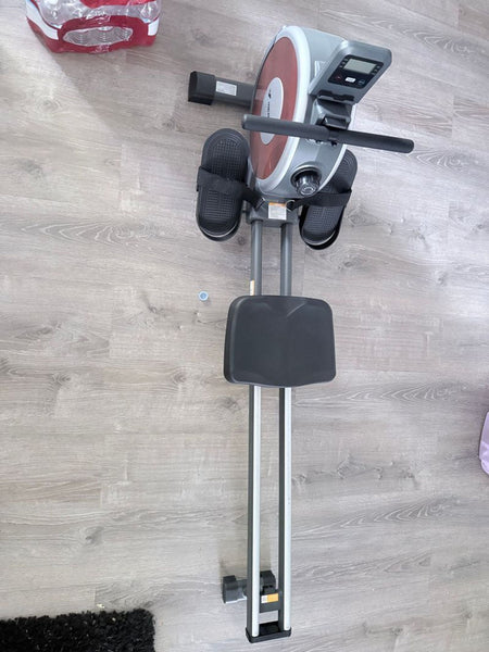 1. Rowing machine gym equipment on display, with sturdy frame and digital console.  