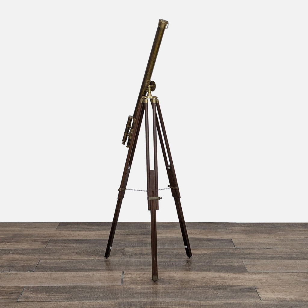 Vintage brass telescope on a wooden tripod, adjustable height.